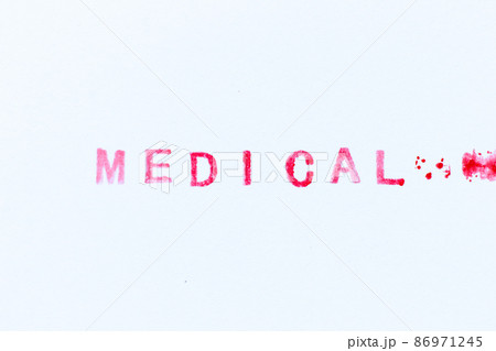 Red color ink rubber stamp in word medical on white paper background 86971245