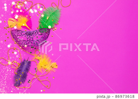 Carnival mask colored feathers traditional sequin beads for Mardi Gras festival purple background 86973618