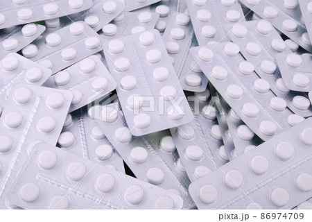 Background from the big heap of white tablets 86974709