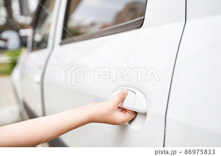 Children hand opening car door. Stole service concept. Criminal lifestyle Children hand opening car door. Stole service concept. Criminal lifestyle 86975833