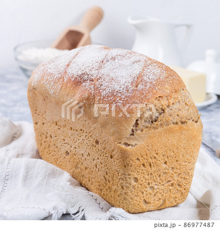 Loaf of homemade no knead sandwich bread with white cloth, square 86977487