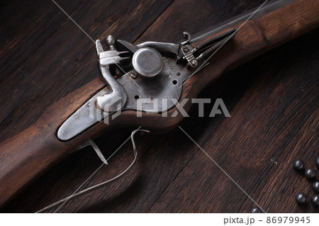17th century ancient flintlock musket with powder flask and led bullets. 86979945