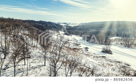 Sun lights up the winter hills Sun lights up the winter hills 86982656