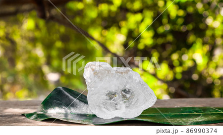 Crystal clear alum cubes or Potassium alum on wood plank. Chemical compound substance. Concept for beauty , spa and underarm treatment industrial. Crystal clear alum cubes or Potassium alum on wood plank. Chemical compound substance. Concept for beauty , spa and underarm treatment industrial. 86990374