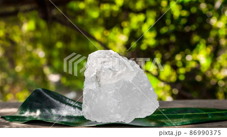 Crystal clear alum cubes or Potassium alum on wood plank. Chemical compound substance. Concept for beauty , spa and underarm treatment industrial.  86990375