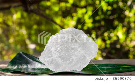 Crystal clear alum cubes or Potassium alum on wood plank. Chemical compound substance. Concept for beauty , spa and underarm treatment industrial. Crystal clear alum cubes or Potassium alum on wood plank. Chemical compound substance. Concept for beauty , spa and underarm treatment industrial. 86990376