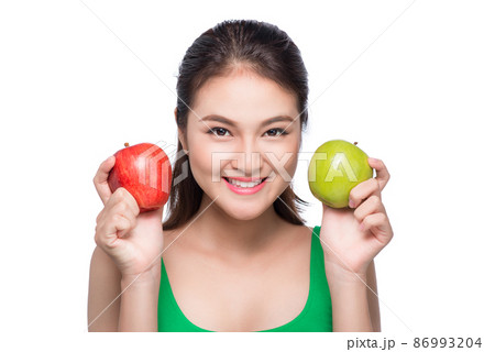 Portrait of asian woman holding red and green apple on white background Portrait of asian woman holding red and green apple on white background 86993204
