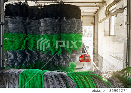 Automatic car wash service in action on a sunny day 86995274