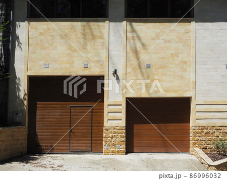 Automatic garage gate and front door in a private apartment building in a modern style 86996032