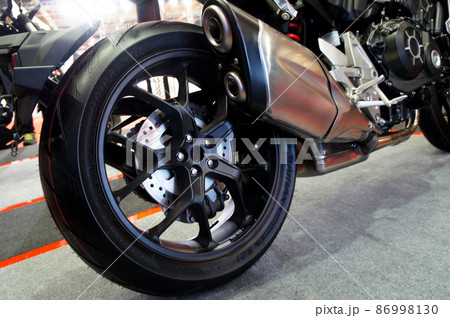 SELANGOR, MALAYSIA - MARCH 4, 2021: Motorcycle tires made from quality rubber. The tires selected must be in accordance with the specifications recommended by the manufacturer. SELANGOR, MALAYSIA - MARCH 4, 2021: Motorcycle tires made from quality rubber. The tires selected must be in accordance with the specifications recommended by the manufacturer. 86998130