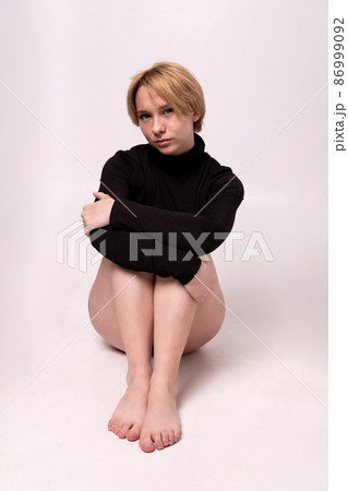 The girl sits on a white background in a black jacket Adult attractive background beautiful black, In the afternoon erotic figure from fresh for health natural, pretty redhead. Skin slim swimsuit 86999092
