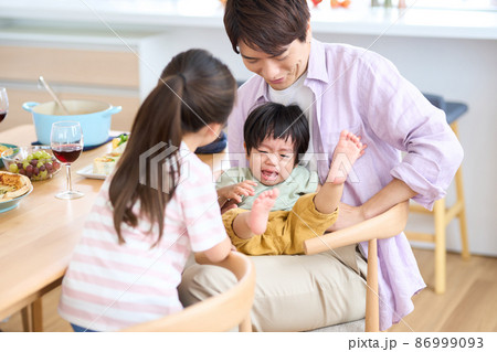 泣きじゃくる1歳児をあやす姉 86999093