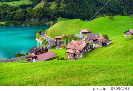 Lungern, canton of Obwalden, Switzerland. A view of rural homes in a green meadow. Lungern, canton of Obwalden, Switzerland. A view of rural homes in a green meadow. 87000248