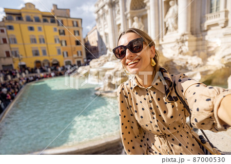 Woman visiting famous di Trevi fountain in Rome Woman visiting famous di Trevi fountain in Rome 87000530