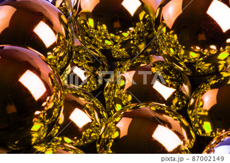 full frame background of golden mirror balls close-up with selective focus 87002149