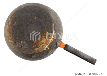 old stained rusty cast iron pan with burnt fat isolated on white bottom up in flat lay perspective 87002246