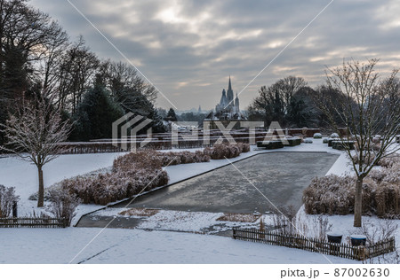 Panoramic view over the Stuyvenberg city park with frozen ponds, snowy reeds and meadows, Laeken, Belgium Panoramic view over the Stuyvenberg city park with frozen ponds, snowy reeds and meadows, Laeken, Belgium 87002630