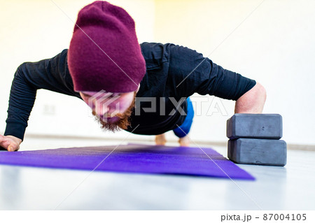 healthy lifestyle concept - man making exercises at home healthy lifestyle concept - man making exercises at home 87004105