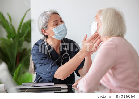 Elderly woman visited by home care specialist Elderly woman visited by home care specialist 87016064