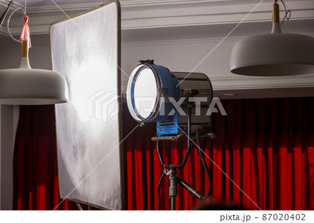 Process of filming. Spotlight illuminates. Movie set with many lamps outdoor. Movie lights outdoor Process of filming. Spotlight illuminates. Movie set with many lamps outdoor. Movie lights outdoor 87020402