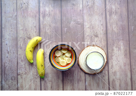 glass of milk and banana on table at morning glass of milk and banana on table at morning 87022177