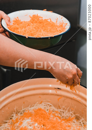 Adding carrots to cabbage, the process of cooking sauerkraut, finely chopped cabbage and carrots. Adding carrots to cabbage, the process of cooking sauerkraut, finely chopped cabbage and carrots. 87023000