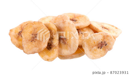 Banana chips isolated on white background. Dried fruit snack. Banana chips isolated on white background. Dried fruit snack. 87023931