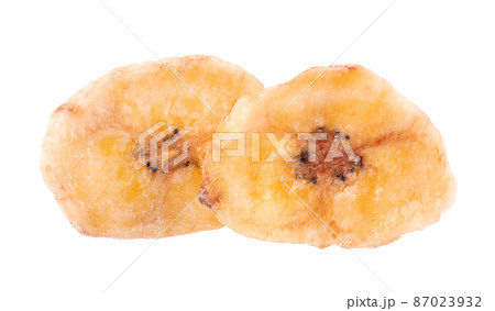 Banana chips isolated on white background. Dried fruit snack. Banana chips isolated on white background. Dried fruit snack. 87023932