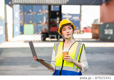 Professional foreman work at Container cargo site check up goods in container.  87025341