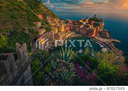 Vernazza view with harbor and mediterranean plants at sunset, Italy Vernazza view with harbor and mediterranean plants at sunset, Italy 87027503