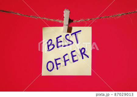 Best Offer text on a yellow sticker on a rope with clothespins on a red background Best Offer text on a yellow sticker on a rope with clothespins on a red background 87029013