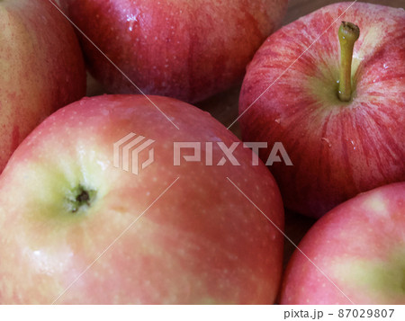 Macro photo of ripe red apples of gala and Ligol varieties. Apple close-up. Macro photo of ripe red apples of gala and Ligol varieties. Apple close-up. 87029807