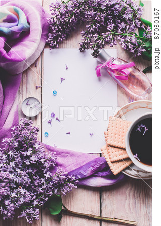 Morning cup of tee, cookies, and lilac flower on wooden table from above. Beautiful breakfast. Flat lay style with copy space Morning cup of tee, cookies, and lilac flower on wooden table from above. Beautiful breakfast. Flat lay style with copy space 87030167