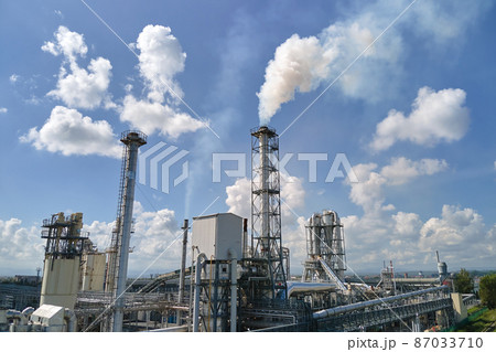 Aerial view of factory with high plant manufacture structure. Global production and manufacturing concept. 87033710