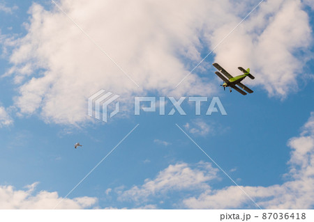 Biplane flying in blue sky at Air Show 87036418