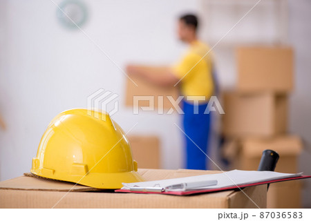 Young male contractor doing home relocation Young male contractor doing home relocation 87036583