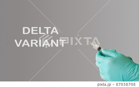 delta variant covid-19 new strain. Doctor's hand in a blue glove with a syringe. Delta option. delta variant covid-19 new strain. Doctor's hand in a blue glove with a syringe. Delta option. 87038708