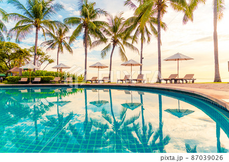 Umbrella and chair around swimming pool in resort hotel for leisure travel and vacation neary sea ocean beach Umbrella and chair around swimming pool in resort hotel for leisure travel and vacation neary sea ocean beach 87039026