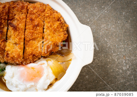 Japanese fried pork cutlet (katsudon) with onion soup and egg 87039085