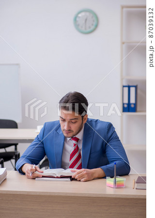 Young attractive employee working in the office 87039132