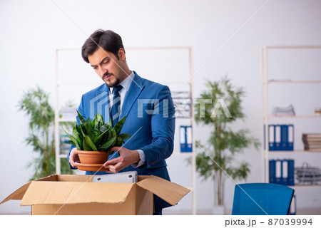 Young male employee in business relocation concept 87039994