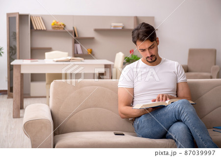 Young male student studying at home during pandemic Young male student studying at home during pandemic 87039997