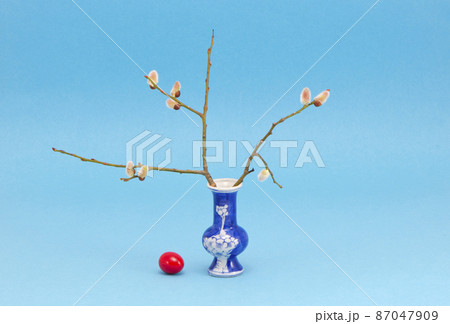easter time vase with egg and pussy-willow 87047909
