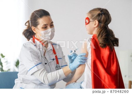 Doctor vaccinating child Doctor vaccinating child 87048260