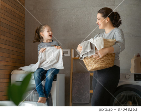 family doing laundry family doing laundry 87048263