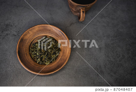 tea leaves on a clay bowl tea leaves on a clay bowl 87048407