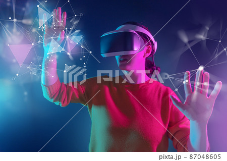 Woman with VR virtual reality goggles 87048605