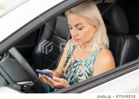 Woman driving car Woman driving car 87048858