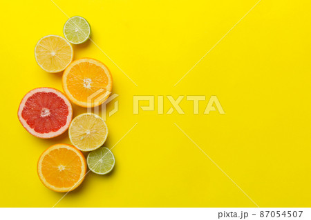 Fruit background. Colorful fresh fruits on colored table. Orange, lemon, grapefruit Space for text healthy concept. Flat lay, top view, copy space Fruit background. Colorful fresh fruits on colored table. Orange, lemon, grapefruit Space for text healthy concept. Flat lay, top view, copy space 87054507