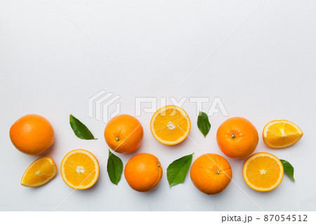 fresh Fruit orange slices on colored background. Top view. Copy Space. creative summer concept. Half of citrus in minimal flat lay with copy space fresh Fruit orange slices on colored background. Top view. Copy Space. creative summer concept. Half of citrus in minimal flat lay with copy space 87054512